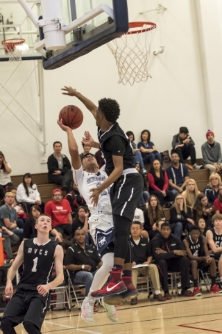 Mountain View Saints guard Tyrell Brooks (22) blocks a shot by Meadows Mustangs guard Ashees ...