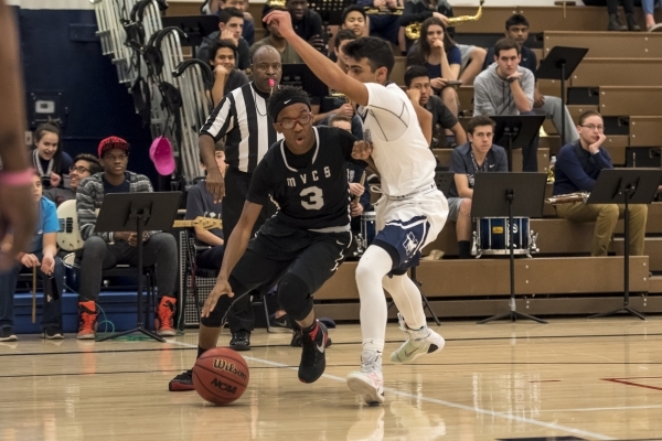 Mountain View Saints guard Terrence Brooks (3) goes around Meadows Mustangs guard Asheesh Ch ...