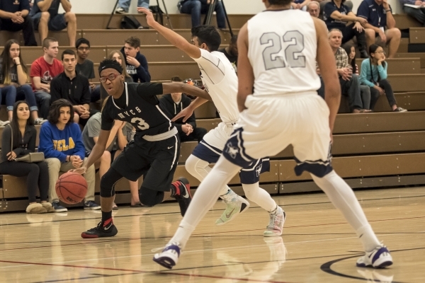 Mountain View Saints guard Terrence Brooks (3) goes around Meadows Mustangs guard Asheesh Ch ...