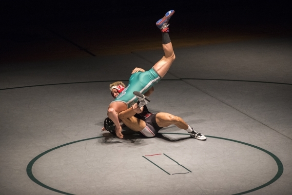 Las Vegas High‘s Andrew Stokes, bottom, wrestles Green Valley‘s Adrien Ojeda dur ...