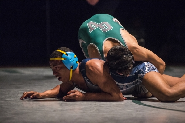 Green Valley‘s Giullian Nakamatsu, top, wrestles Canyon Spring WIlliam Stevenson durin ...