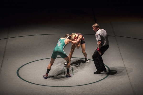 Green Valley‘s Adrien Ojeda, left, wrestles Las Vegas High‘s Andrew Stokes durin ...