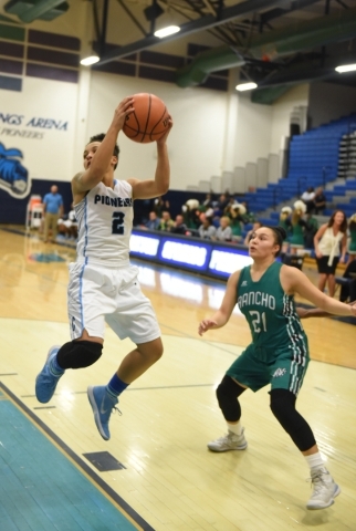 Canyon Springs Aleza Bell (2) grabs a rebound against Rancho‘s Tatianna Lee (21) durin ...