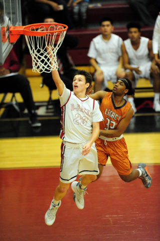 Desert Oasis forward Daron Fuglesten (23) goes up for a shot against Legacy guard Kameron De ...