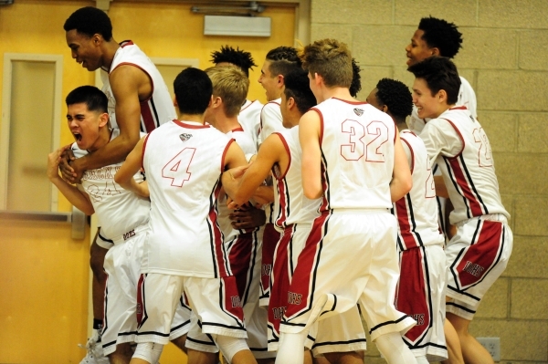 Desert Oasis players celebrate their 87-65 victory over Legacy during their prep basketball ...