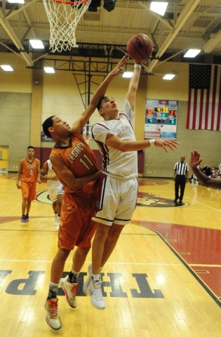 Desert Oasis guard Andrue Aguilera (0) goes up for a shot against Legacy forward Darious Dun ...