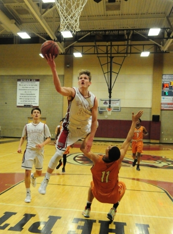 Desert Oasis forward Jacob Heese (32) fouls Legacy forward Darious Dunson (11) in the second ...