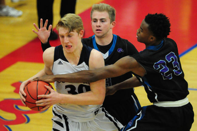 Silverado guards Evan Tafoya and Errol Newman (23) fight Coronado forward Kennedy Koehler (3 ...