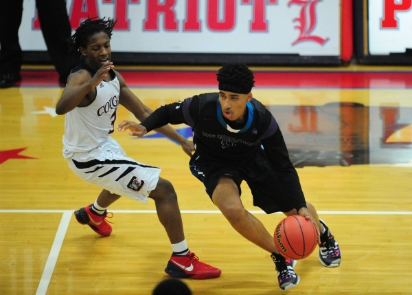 Silverado guard Tyric Johnson (11) dribbles upcourt against Coronado guard Nick Davis (3) in ...