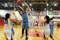 Foothill guard Rae Burrell (12) and Canyon Springs forward Alexia Thrower (20) fight for a r ...