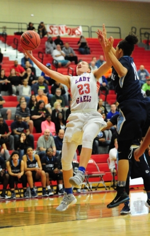 Bishop Gorman guard Megan Jacobs (23) goes up for a shot against Centennial guard Jayden Egg ...