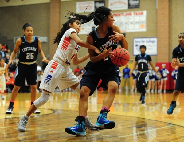 Bishop Gorman guard Ciara Young, left, pokes the ball away from Centennial guard Bailey Thom ...