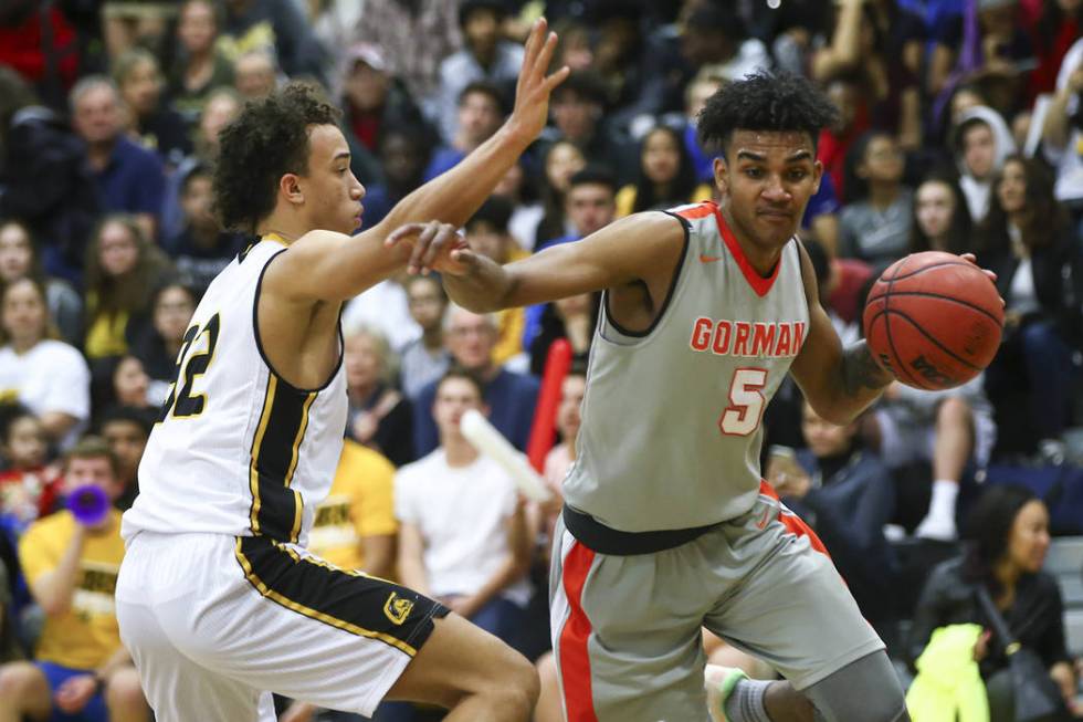 Bishop Gorman’s Jamal Bey (5) drives against Clark’s Ian Alexander (32) during a ...