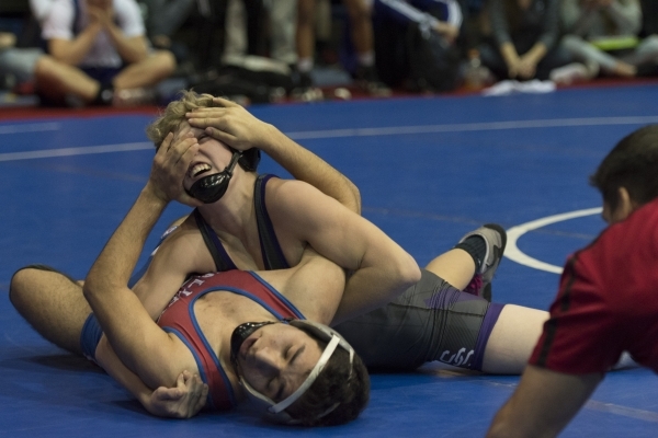 Ulises Munguia, bottom, of Valley High School wrestles Owen Jones of Spanish Springs High Sc ...