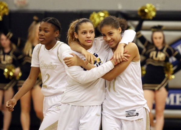 Spring ValleyÂ´s Essence Booker, center, and Kayla Harris, right, embrace near Cheyenne C ...