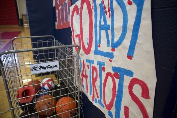 The gym is decorated with a sign to encourage the girls basketball team during practice at L ...