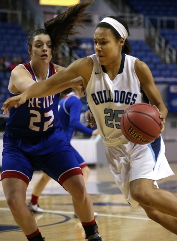 Centennial‘s Samantha Thomas drives past Reno‘s Mckain Murdock during the NIAA D ...