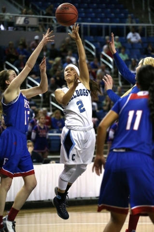 Centennial‘s Melanie Isbell shoots over Reno defenders during the NIAA Division I stat ...