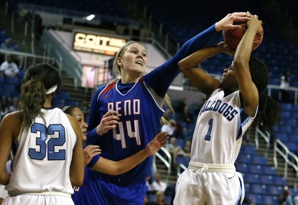 Reno‘s Mallory McGwire tries to block a shot by Centennial‘s Pam WIlmore during ...