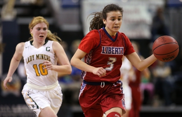 Liberty‘s Celine Quintino runs from Manogue defender Tawni Henderson during the NIAA D ...