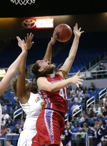 Liberty‘s Nancy Caballero gets fouled by Manogue‘s La-Torae Nixon during the NIA ...