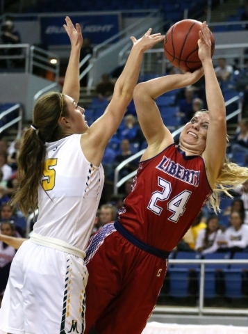 Liberty‘s Gabby Doxtator shoots over Manogue defender Malia Holt during the NIAA Divis ...