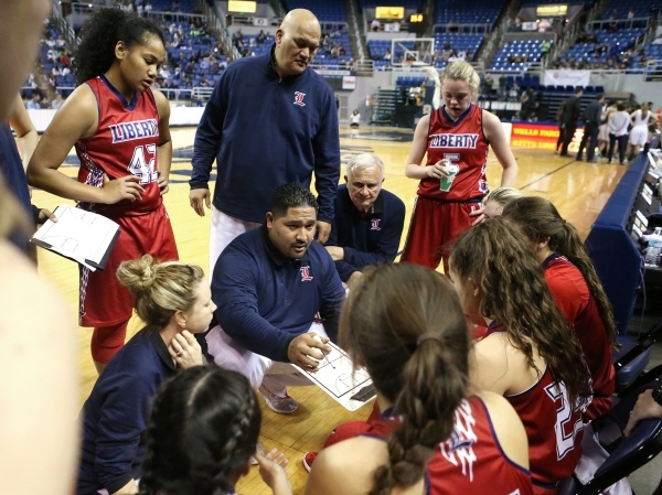 Liberty Head Coach Chad Kapanui, center, talks to the team during a time out in a game again ...