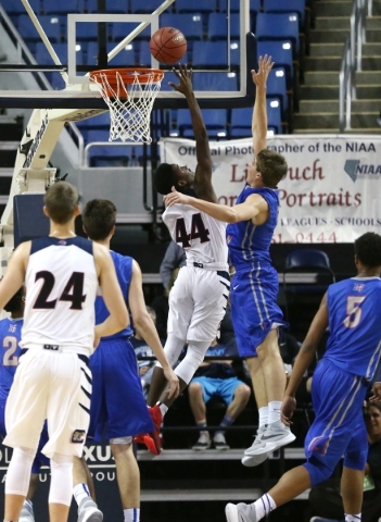 Coronado‘s Tiaeem Comeaux shoots under pressure from Bishop Gorman‘s Byron Frohn ...