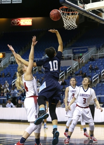 Centennial‘s Jayden Eggleston shoots over Liberty defender Gabby Doxtator during the N ...