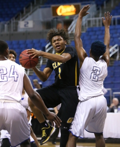 Clark‘s Keyshaun Webb drives past Desert Pines defender Jordan Simon during the NIAA D ...