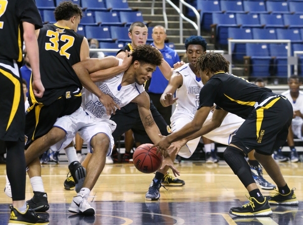 Desert Pines‘ Trevon Abdullah-Booker and Clark‘s Keyshaun Webb fight for a loose ...