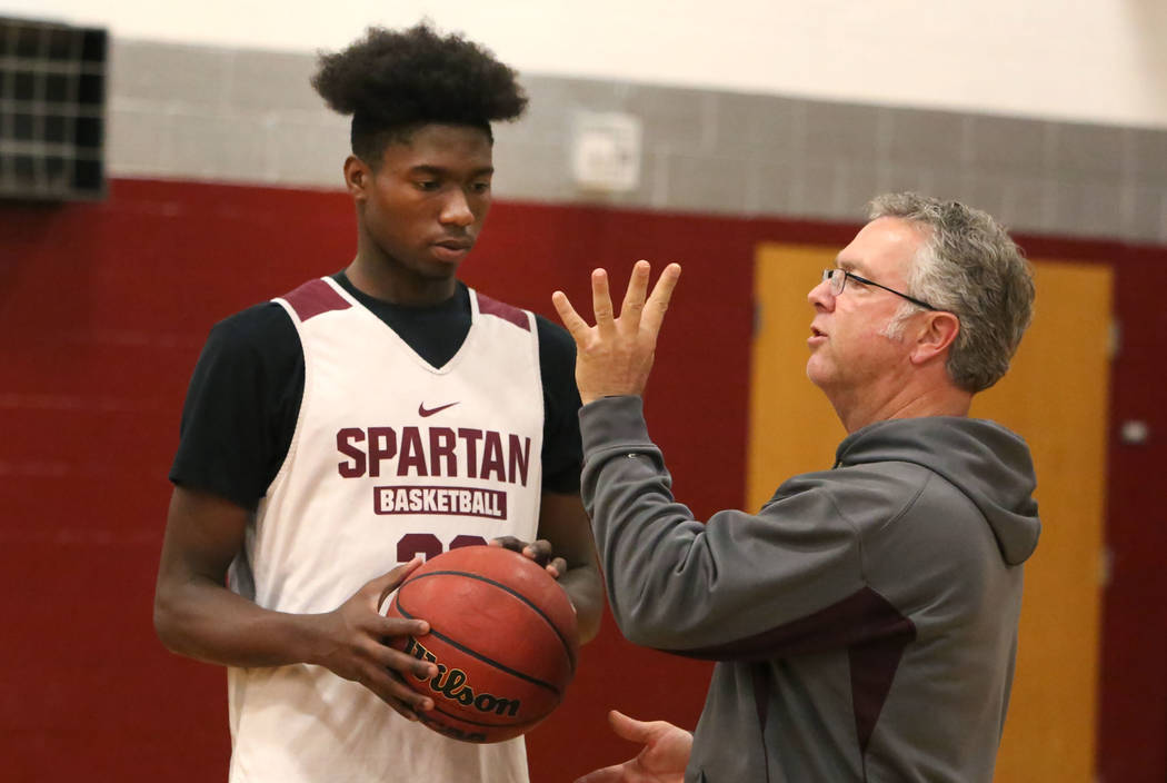 Cimarron-Memorial’s Brian Washington, left, receives instructions from his head coach ...