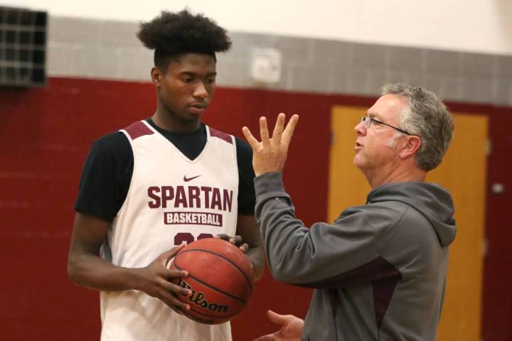 Cimarron-Memorial’s Brian Washington, left, receives instructions from his head coach ...