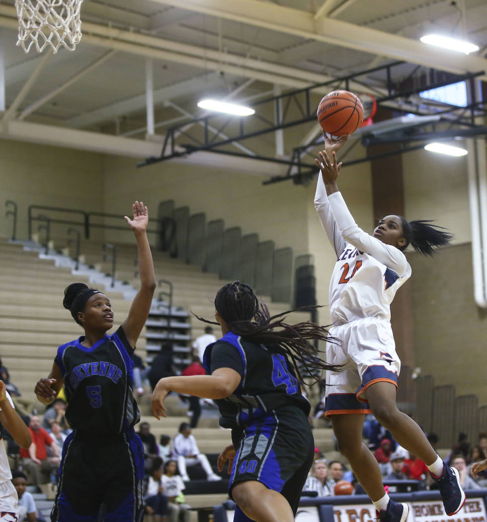 Legacy’s Maiah Yearwood (24) shoots over Cheyenne defenders during a basketball game a ...