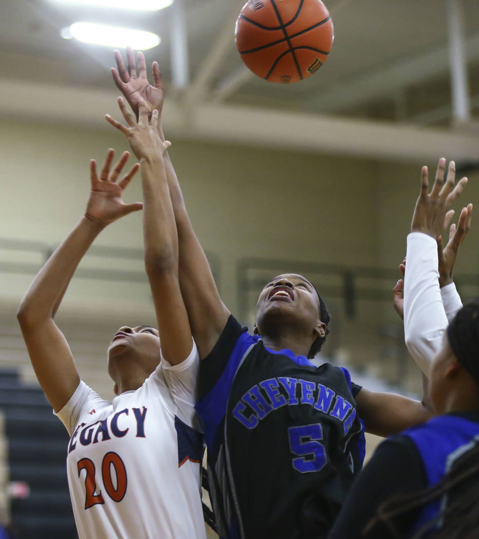 Legacy’s Amiya DeSouza (20) and Cheyenne’s Shanice Aycox (5) fight for a rebound ...