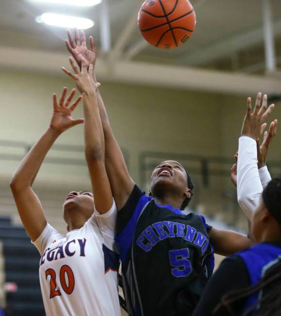 Legacy’s Amiya DeSouza (20) and Cheyenne’s Shanice Aycox (5) fight for a rebound ...