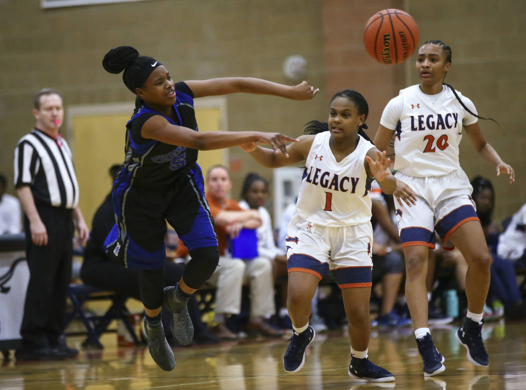 Cheyenne’s Shanice Aycox (5) throws a pass as Legacy’s Samiah Mitchell (1) and L ...