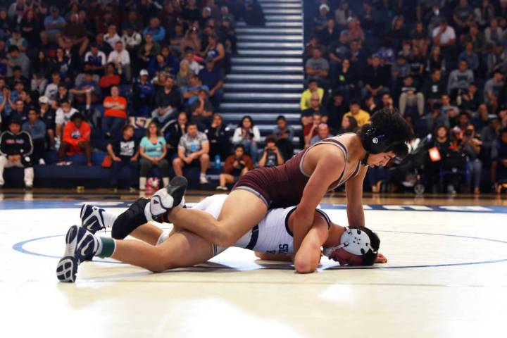 Nathanial Rodriguez, of Cimarron-Memorial High School, pins down Matthew Van Riel, of Shadow ...