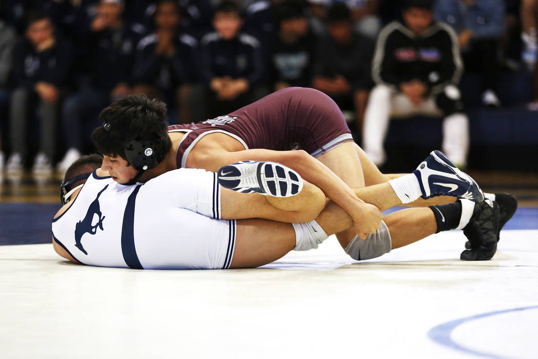 Nathanial Rodriguez, of Cimarron-Memorial High School, pins down Matthew Van Riel, of Shadow ...