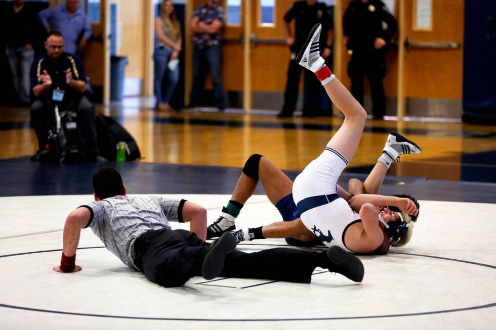 Weston Presser, of Shadow Ridge High School, pins Michael Canada, of Spring Valley High Scho ...