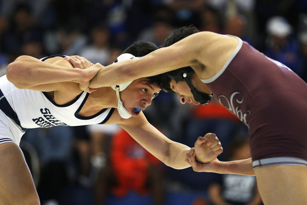 Matthew Van Riel, of Shadow Ridge High School, left, wrestles Nathanial Rodriguez, of Cimarr ...