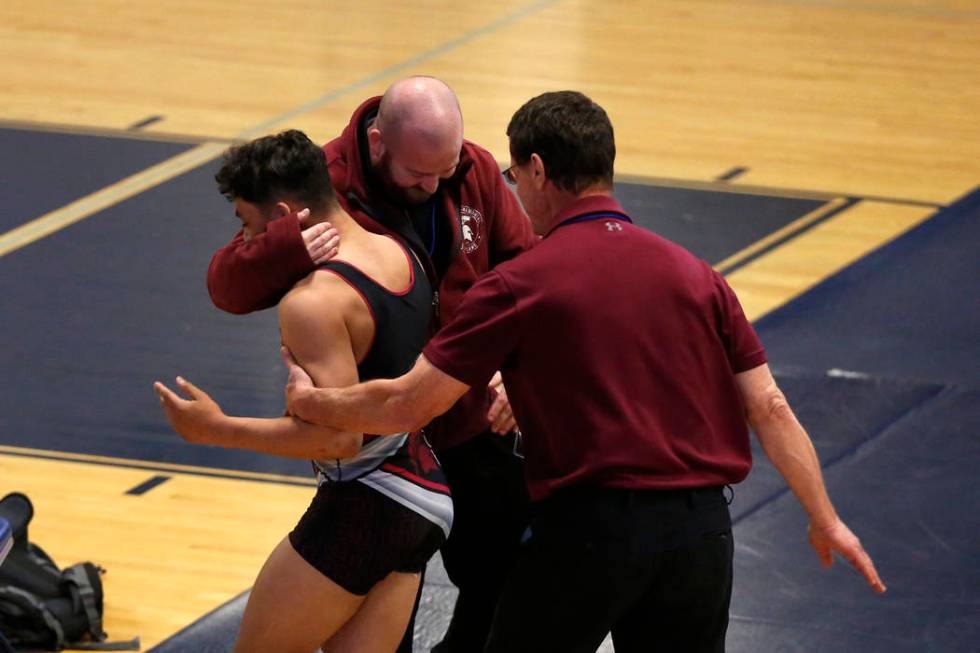 Cimarron-Memorial High School assistant coach John Brokish, left, and coach Mike Garcia cong ...