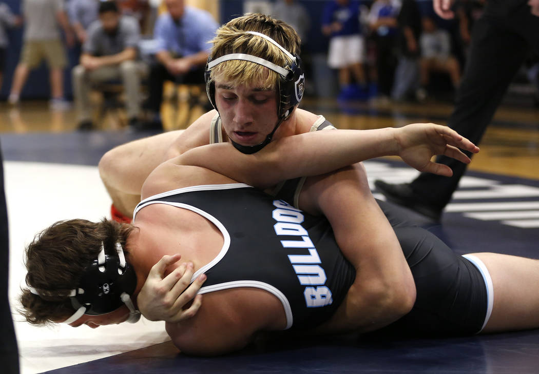 A Faith Lutheran High School player pins down a Centennial High School player during the Sun ...