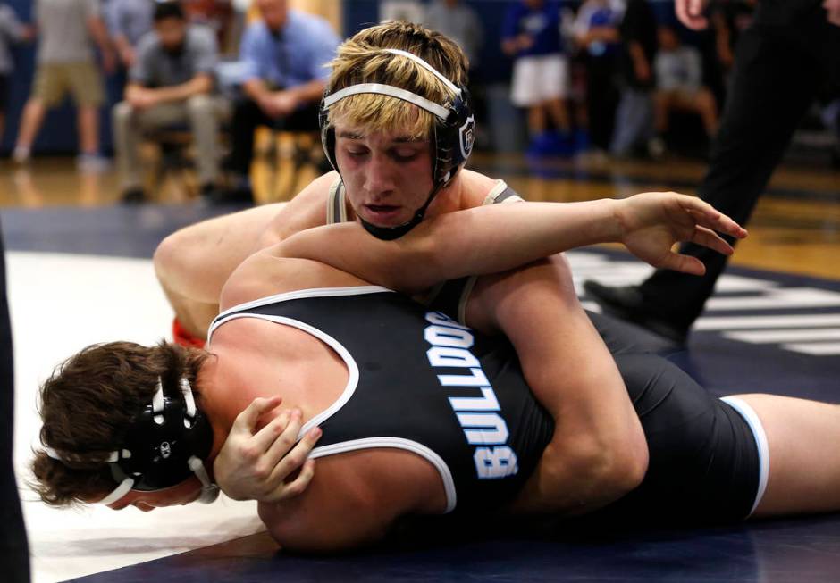 A Faith Lutheran High School player pins down a Centennial High School player during the Sun ...