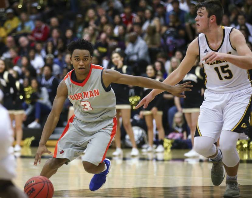 Bishop Gorman’s D.J. Howe (3) drives against Clark’s James Bridges (15) during a ...