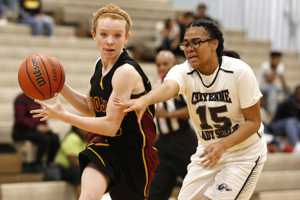 Pahrump Valley’s Makayla Gent (32) runs the ball against Cheyenne High’s Onolina ...