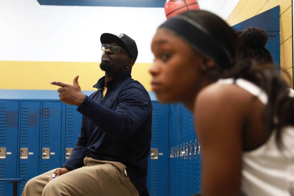 Cheyenne High’s coach Clifton Lott talks to his team during a basketball game against ...