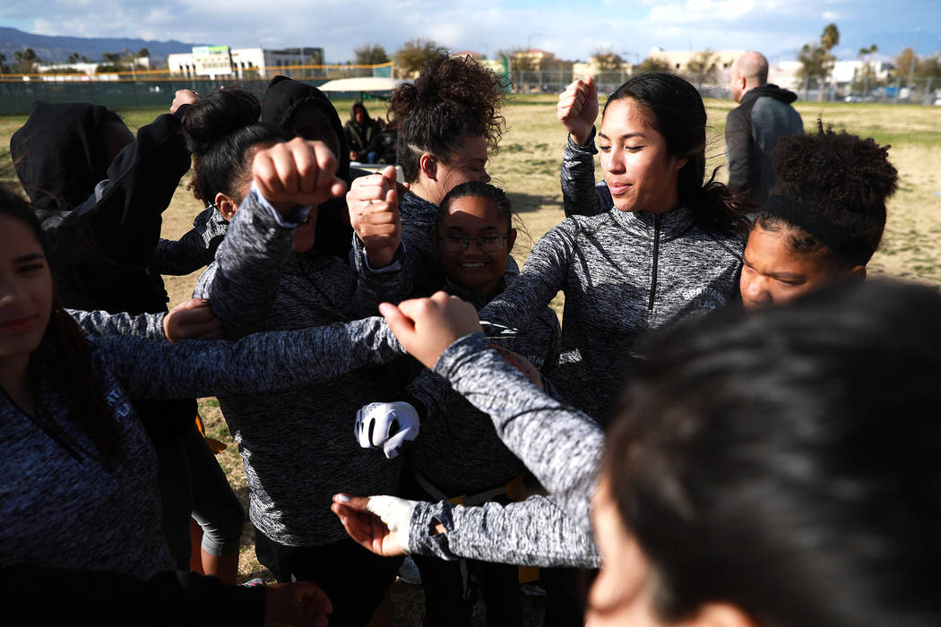 Tiarra Del Rosario, one of the best flag football players in the state, huddles with the tea ...