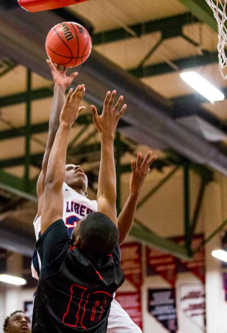 Liberty’s Jordan Wafer (22) goes up for a shot while Las Vegas’ Rashaan Shepherd ...