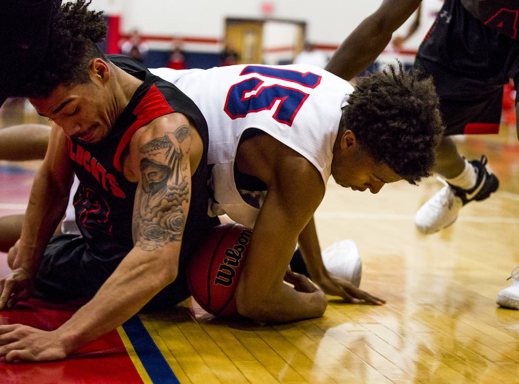 Liberty’s Cameron Burist (15) and Las Vegas’ Donovan Joyner (12) grapple over th ...